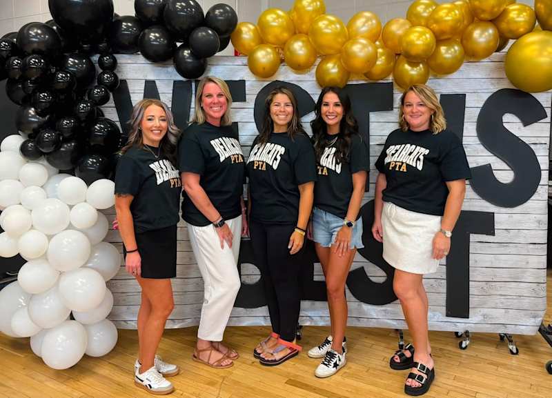 PTA Officers standing in from on a WEST banner and balloons at Open House 2026