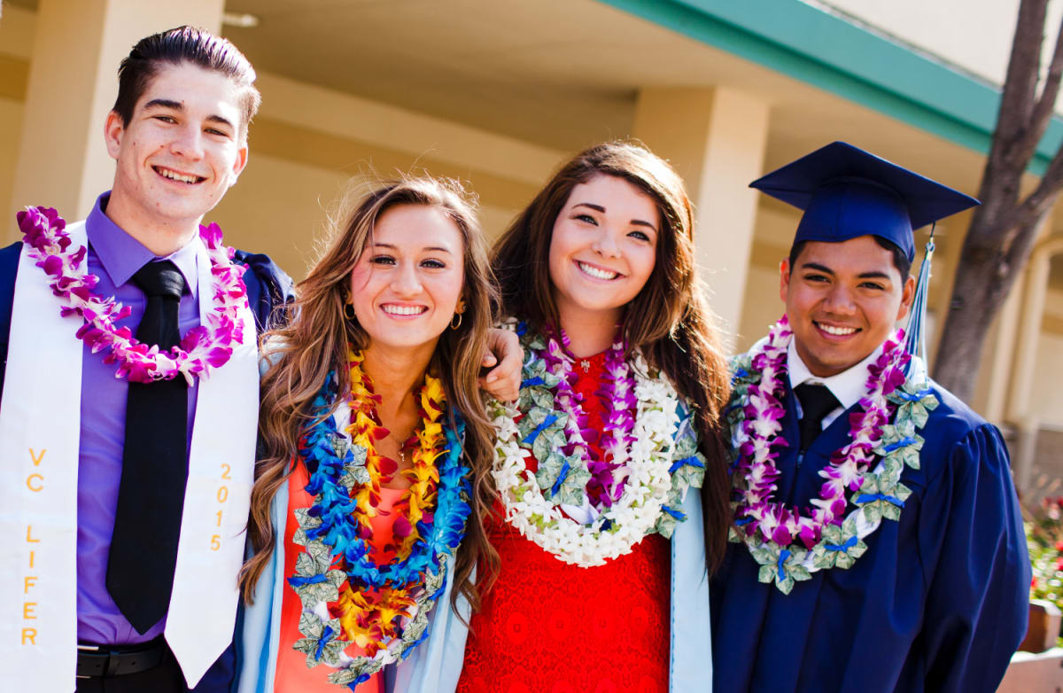 High School graduates pose together after graduation