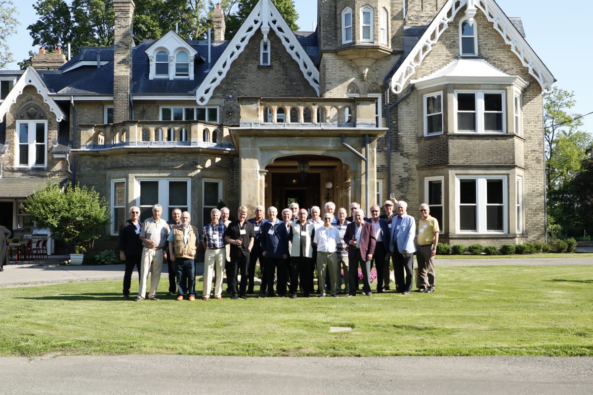 Alumni reconnecting at a campus reception.