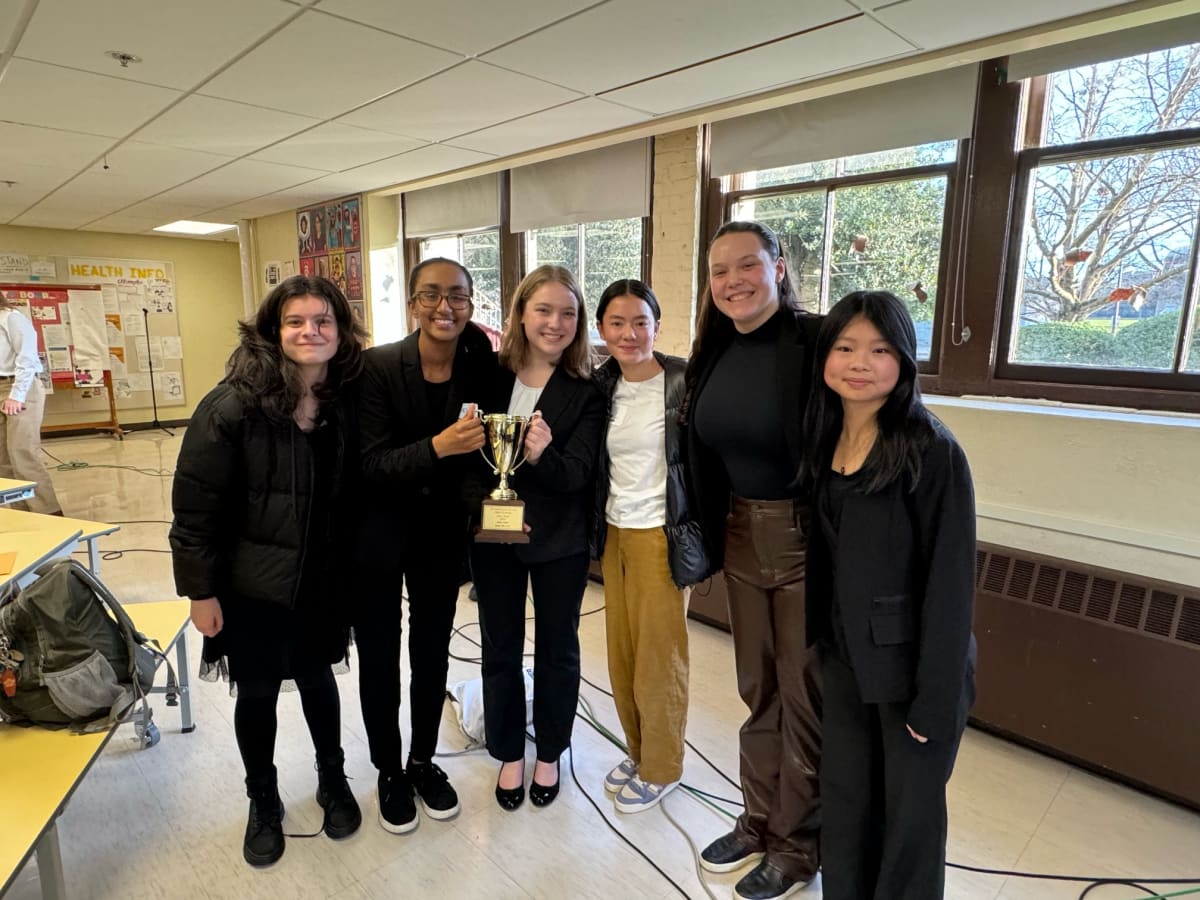 Six Lakeside students smile at the camera, and two of them hold the team's second place trophy.