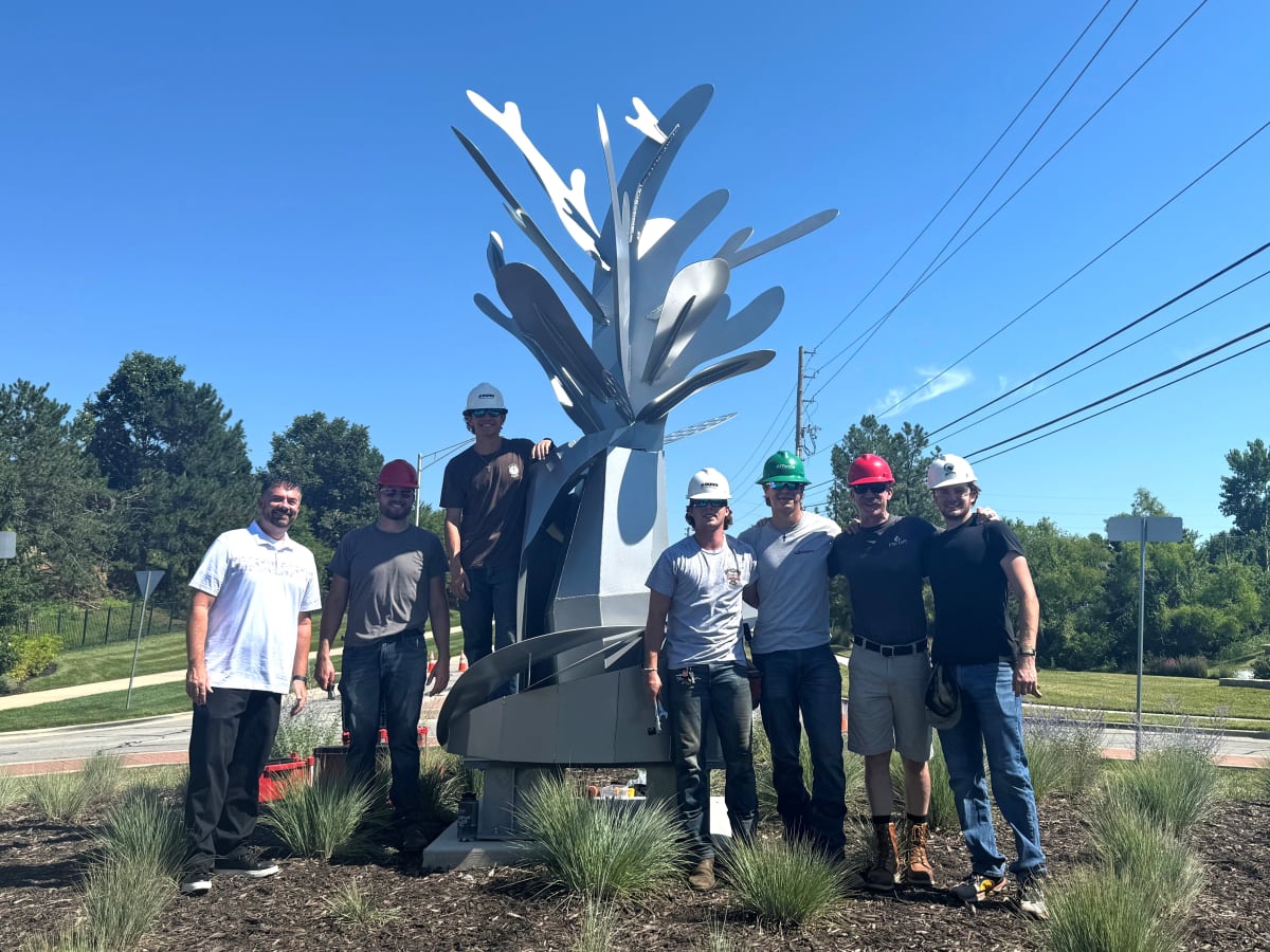 Students and teachers placing sculpture project