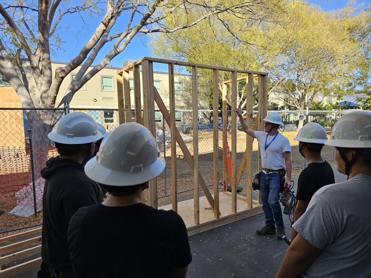 Picture of instructor and students working on the frame for a shed.