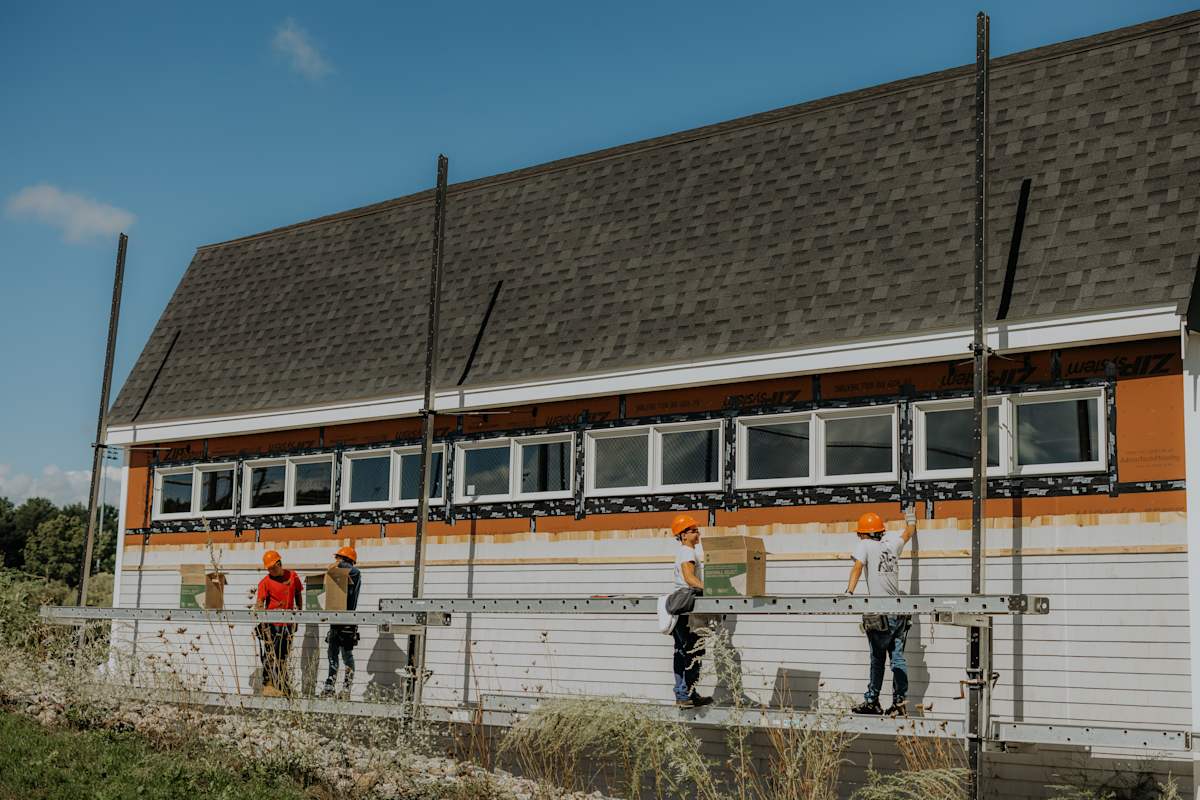 Carpentry students working collaboratively on an outdoor construction project