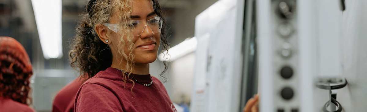 Advanced manufacturing student working with machining equipment