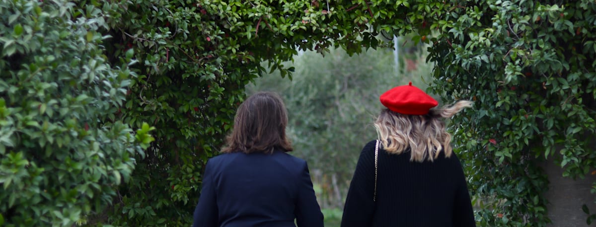 Two CCI students walking together through a garden