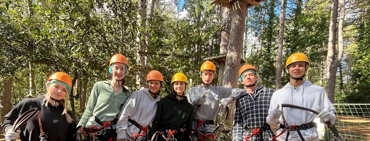 CCI students wearing helmets and safety harnesses during an outdoor activity