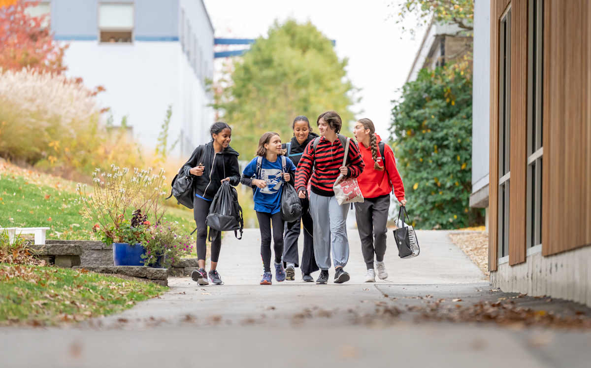Students walking through campus on a beautiful fall day