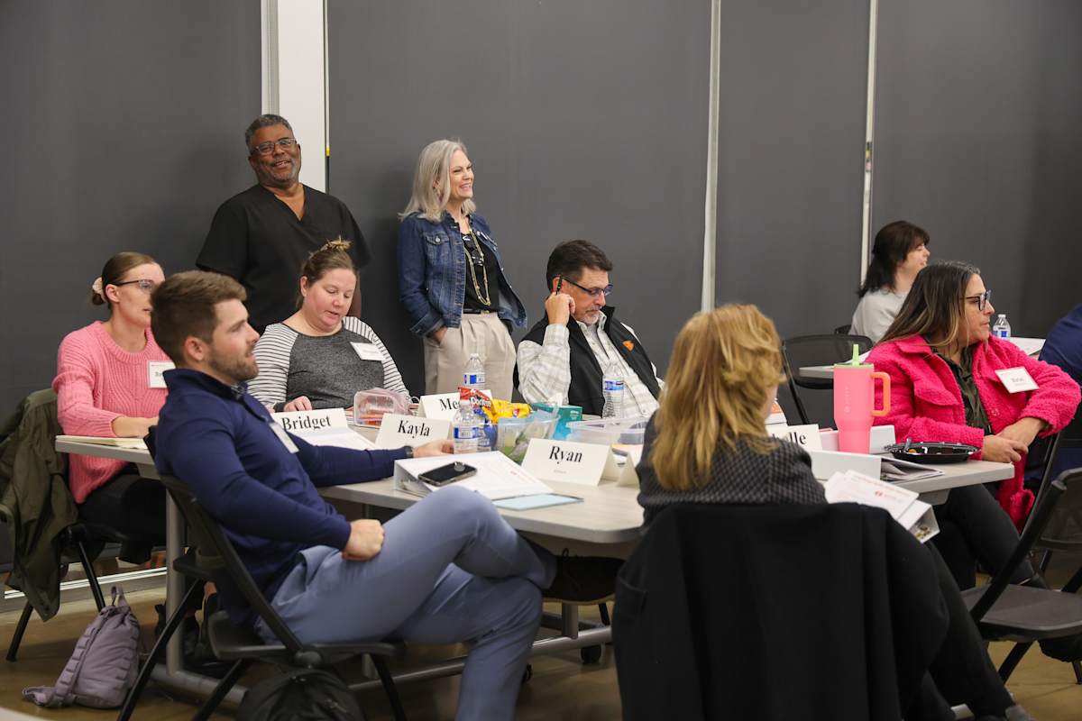 A group sits around a table during a Long Range Facilities Planning Committee discussion.