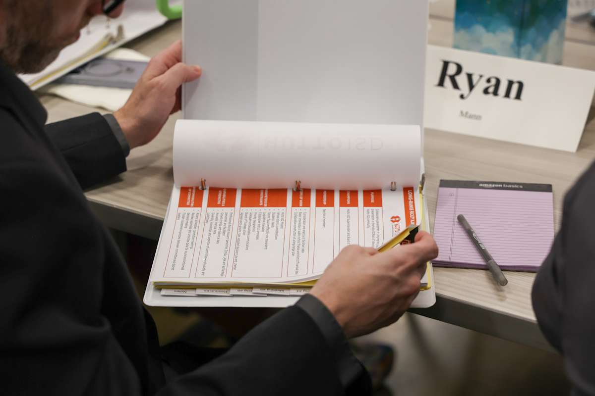 A participant fills out a form at a table during the January 20 planning meeting.