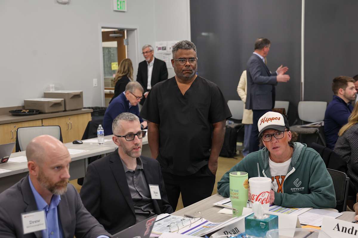 Participants gather around tables during a Long Range Facilities Planning Committee meeting.
