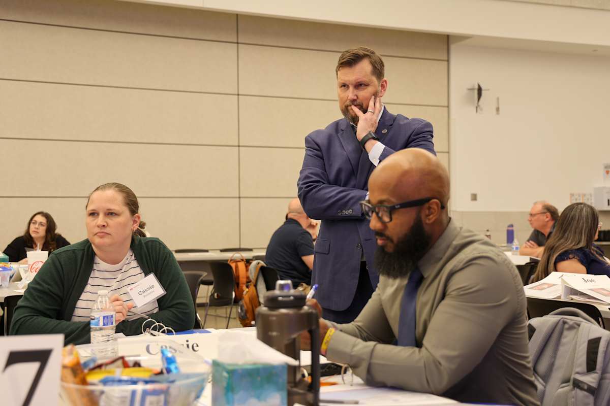 Participants gather around tables during a Long Range Facilities Planning Committee discussion.