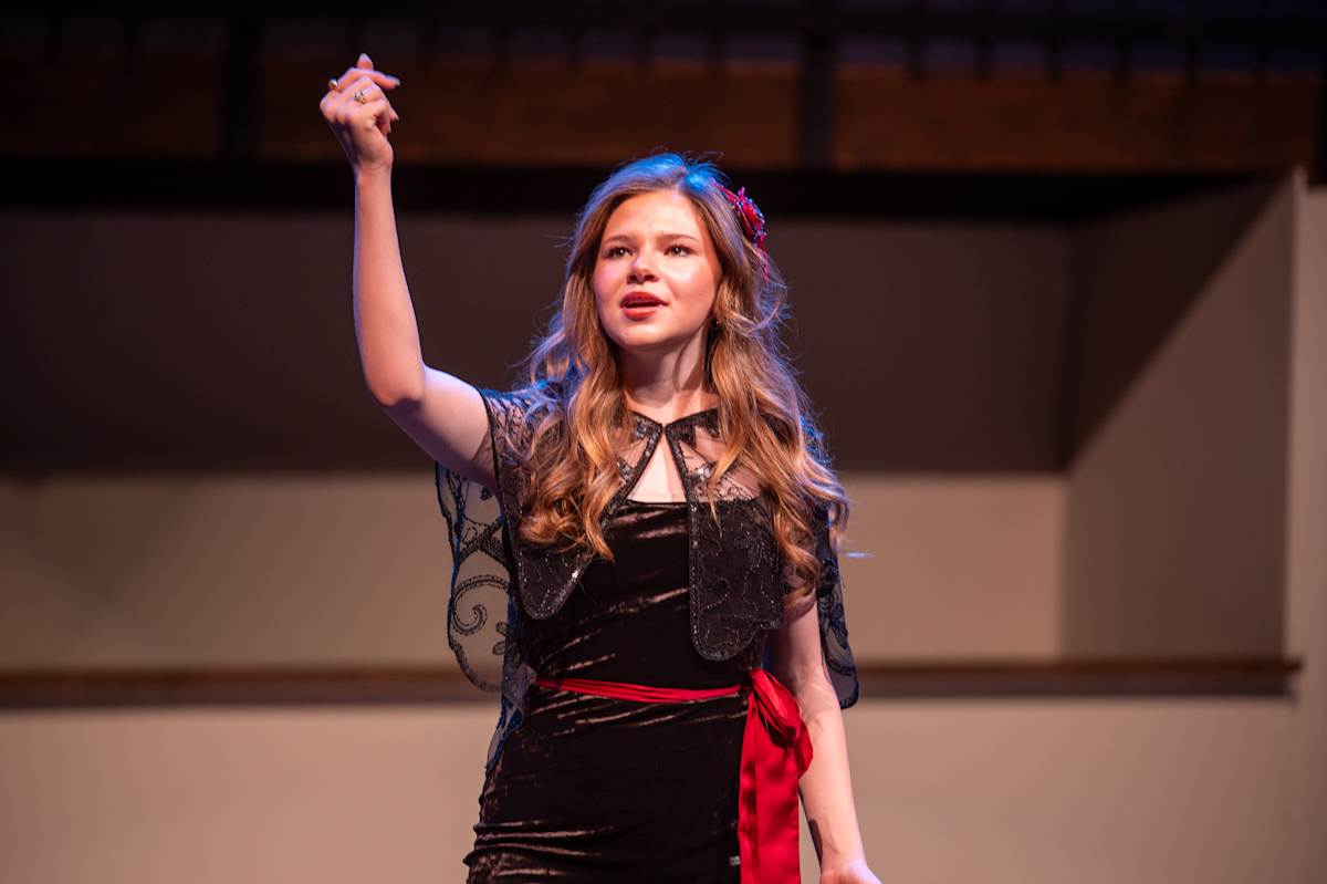 Students joyfully performing on stage