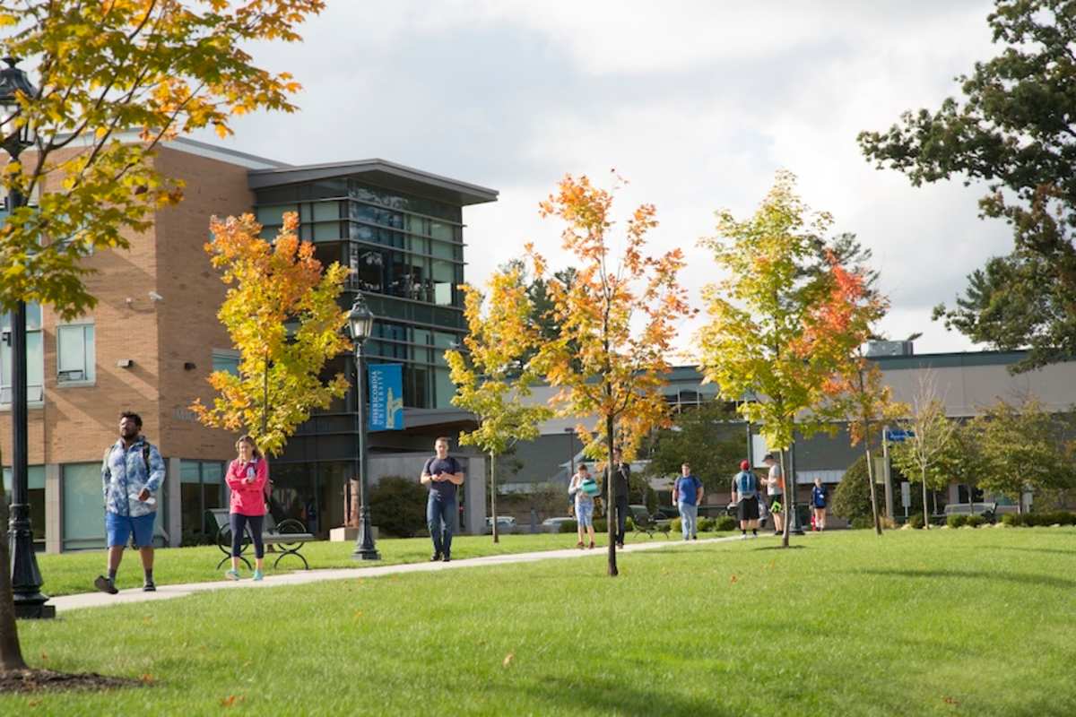 Students walking on campus near the garden
