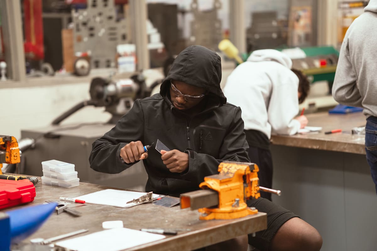 A student in a hoodie works on a project