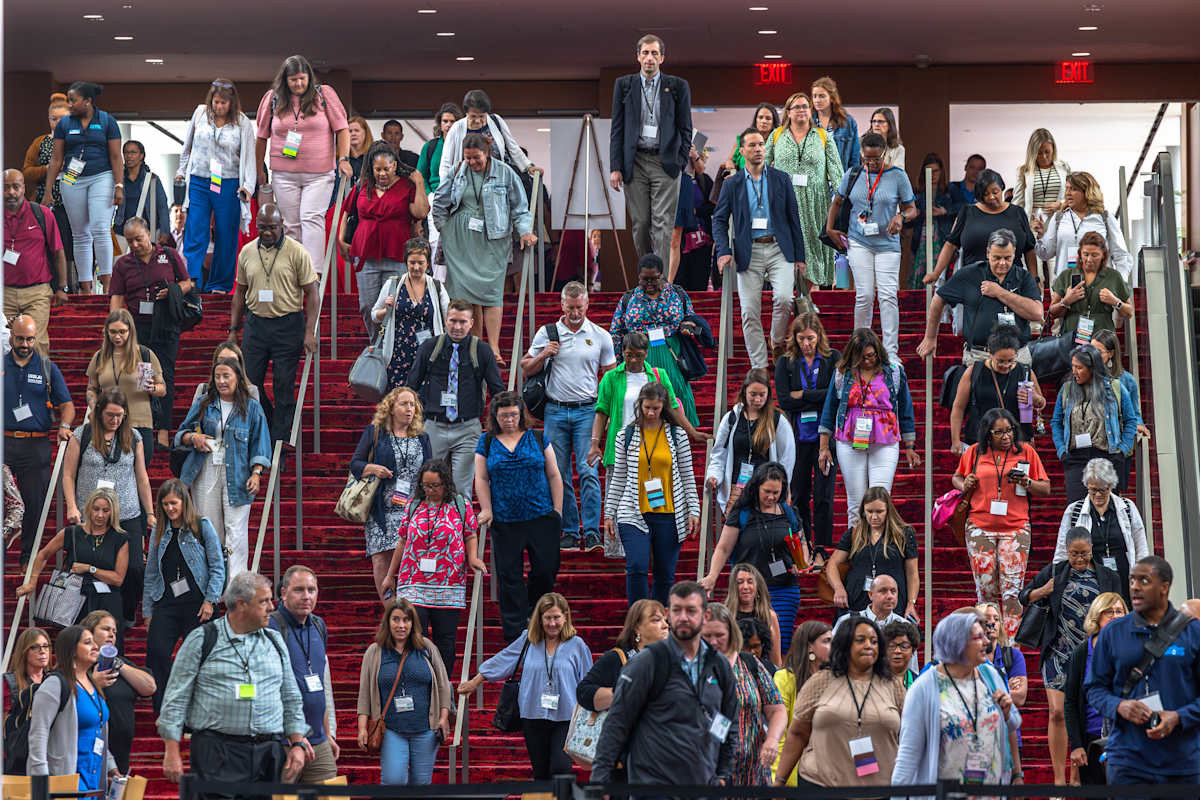 Staff descending stairs during the 2024 CMS Summer Leadership Conference