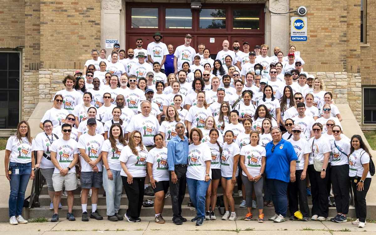 Community Service Day volunteers gather outside the entrance of ALBA.