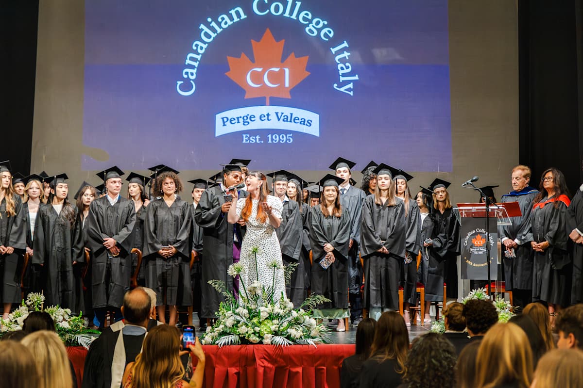 CCI graduates gathered on stage at Teatro Fenaroli