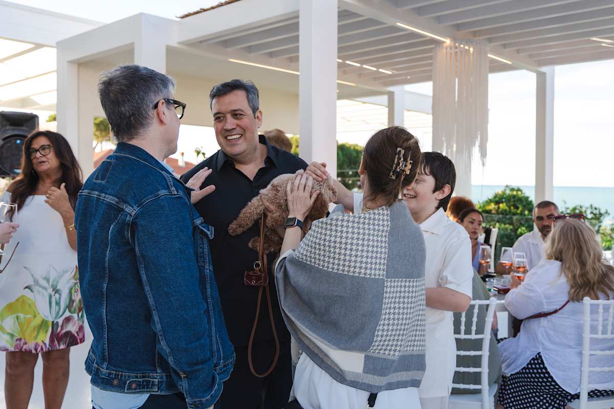 Families and friends laughing together during the seaside aperitivo