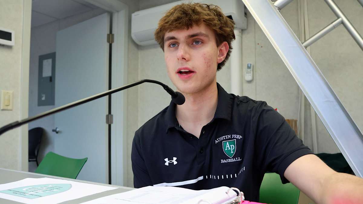 Austin Prep student serving as public address announcer during a varsity baseball game