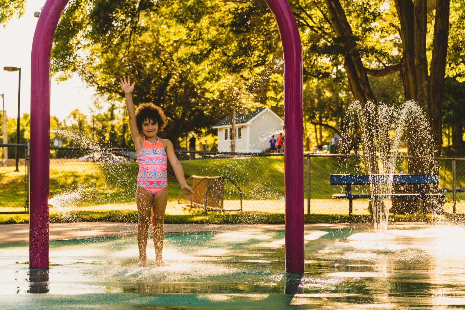 Young girl playing in a splash pad in West Hartford, Connecticut
