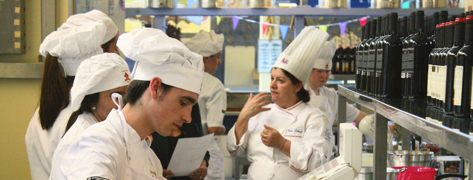 CCI students in chef uniforms taking part in a Cucina demonstration