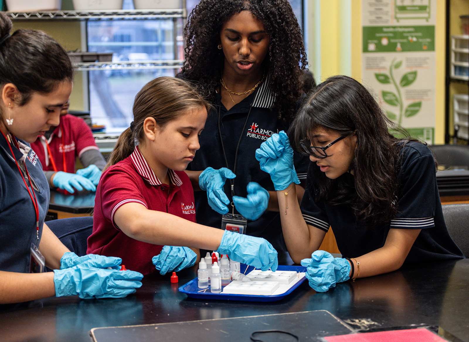 A Harmony teacher guiding students through a hands-on STEM activity