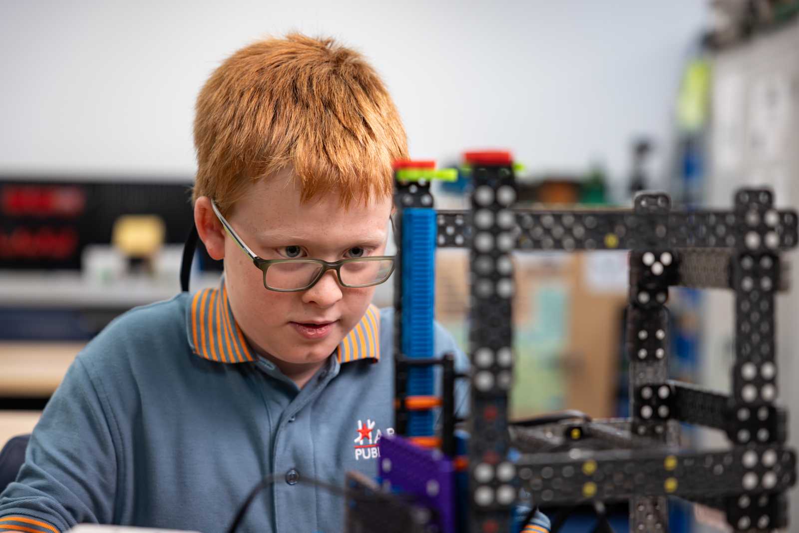 Harmony students building and programming a robot during a robotics class