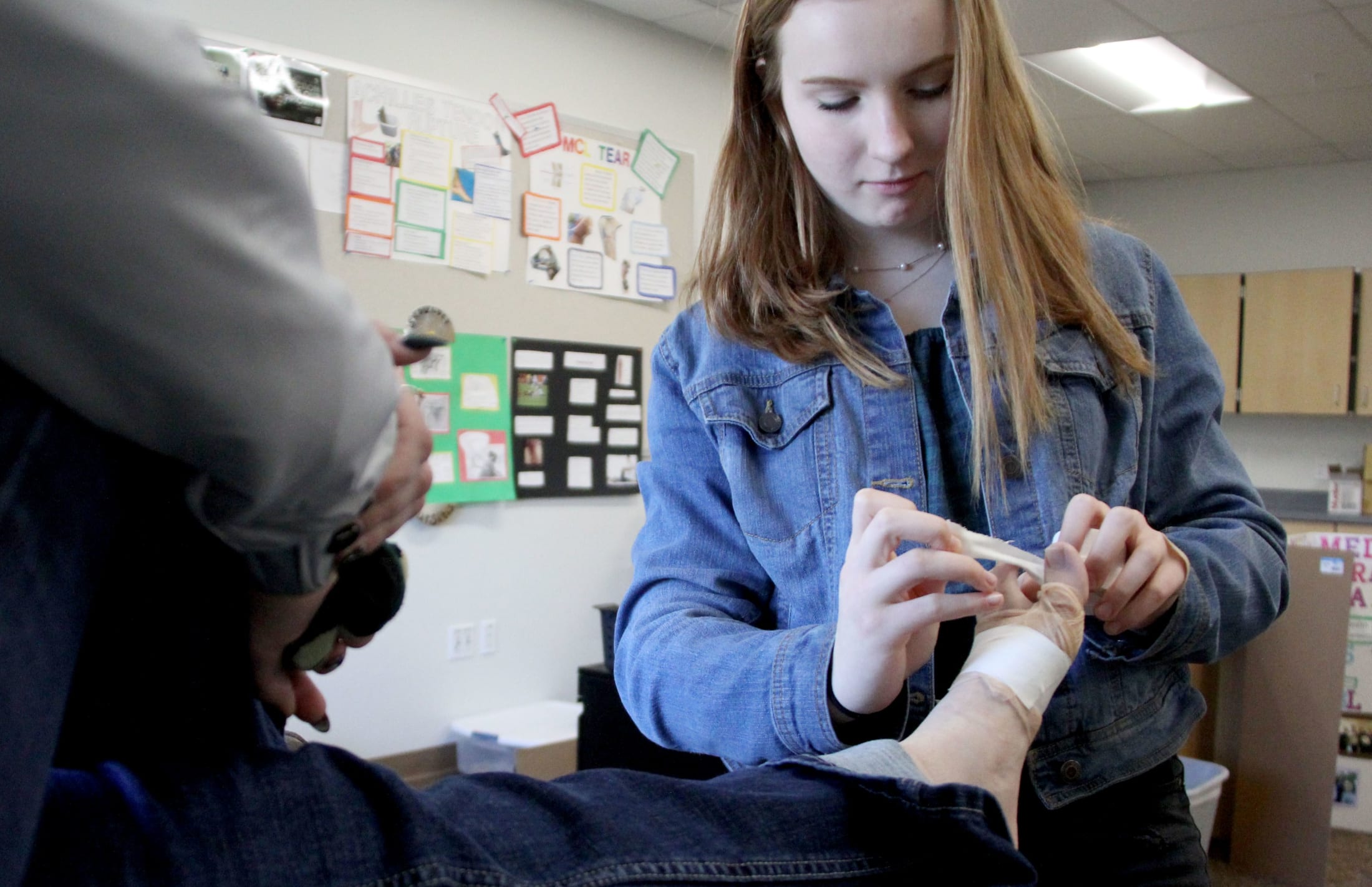 Ashleigh Beach, junior, practices taping during a sports medicine class at Richland High School.