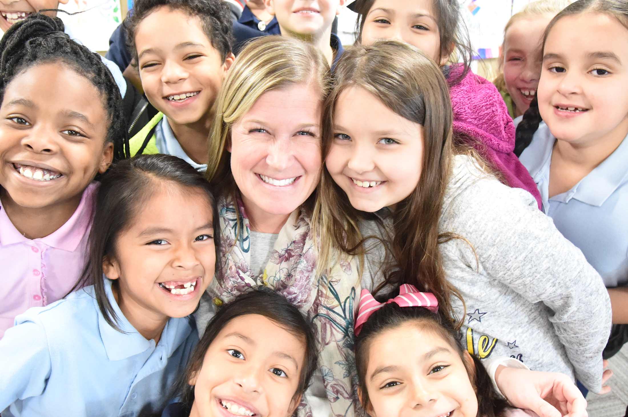 A Tempe Elementary teacher surrounded by her students