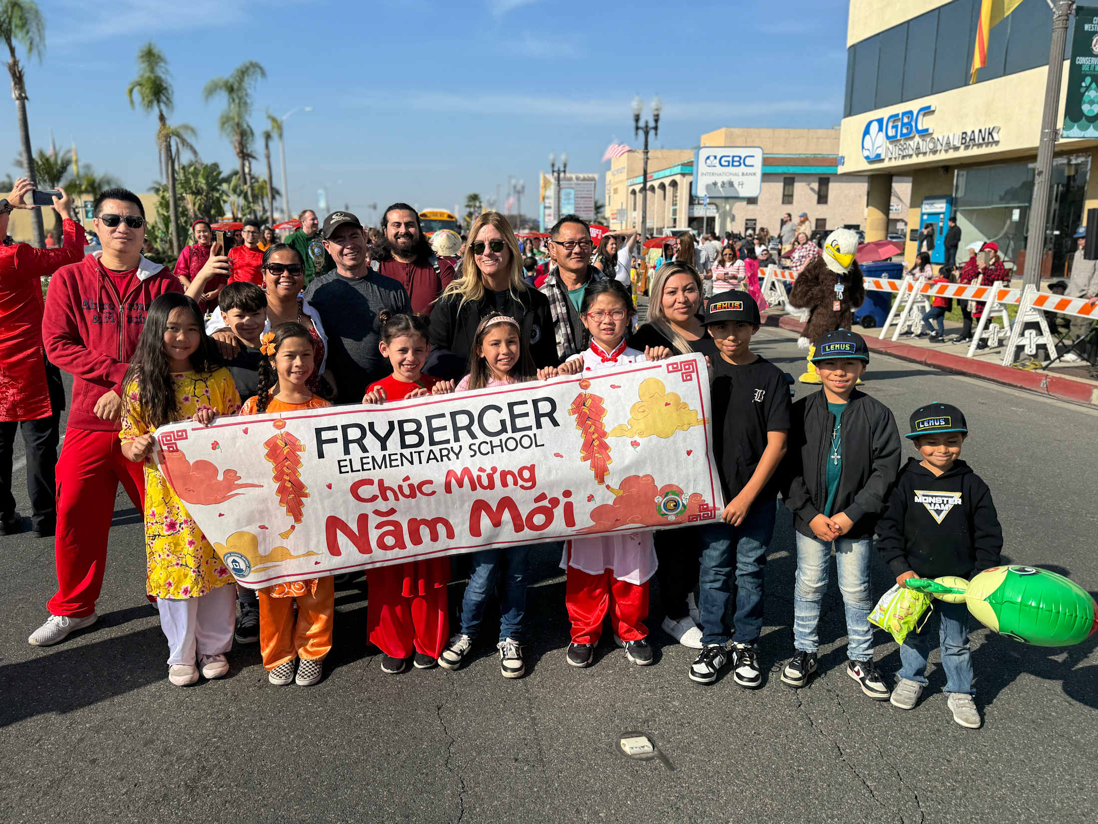 Fryberger students gathered holding a Happy New Year banner in Vietnamese at the Tet Parade.