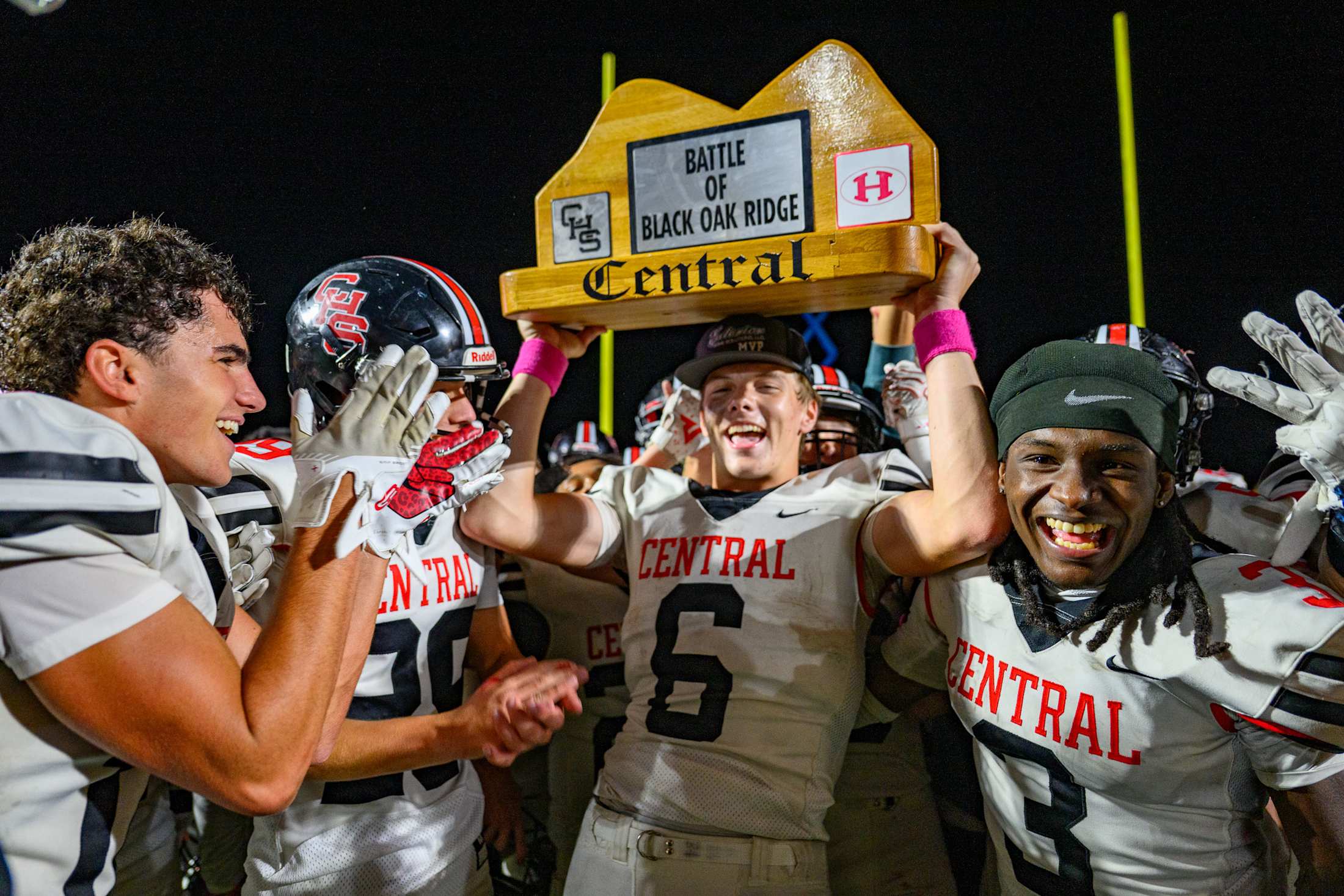 Football players hold up trophy