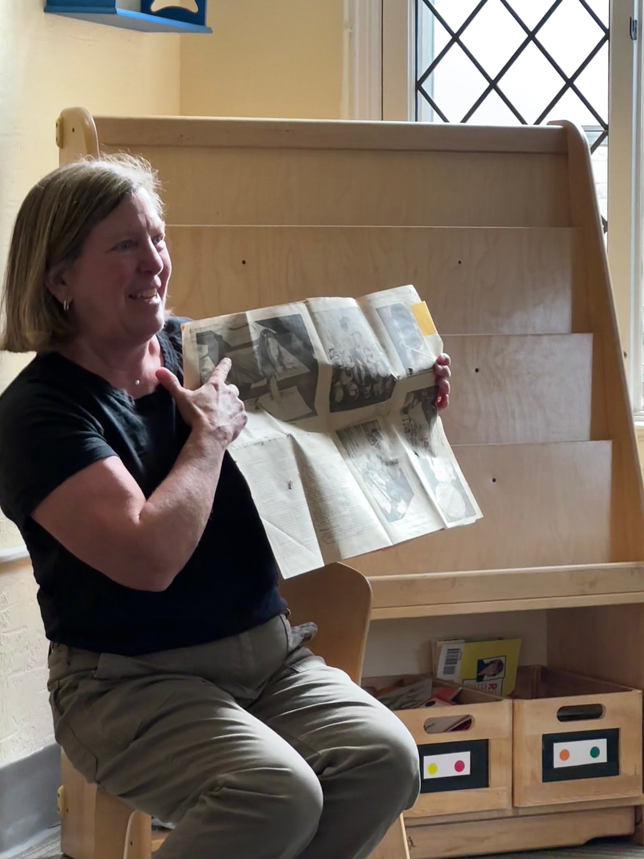 Buffy Naake holding the 1973 Denver Post article that featured her as a Stanley student