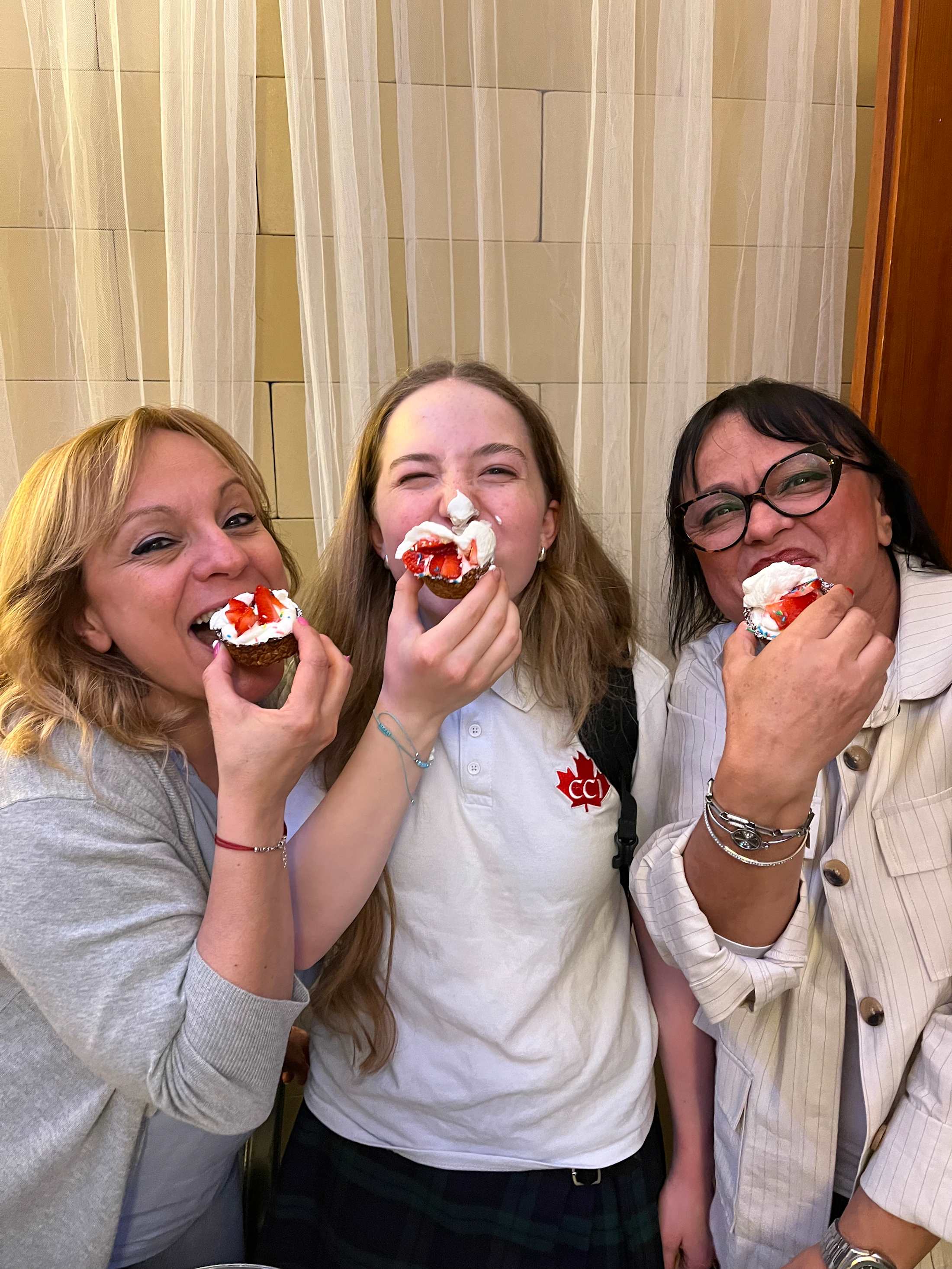 A student and local instructors share pastries during Cucina