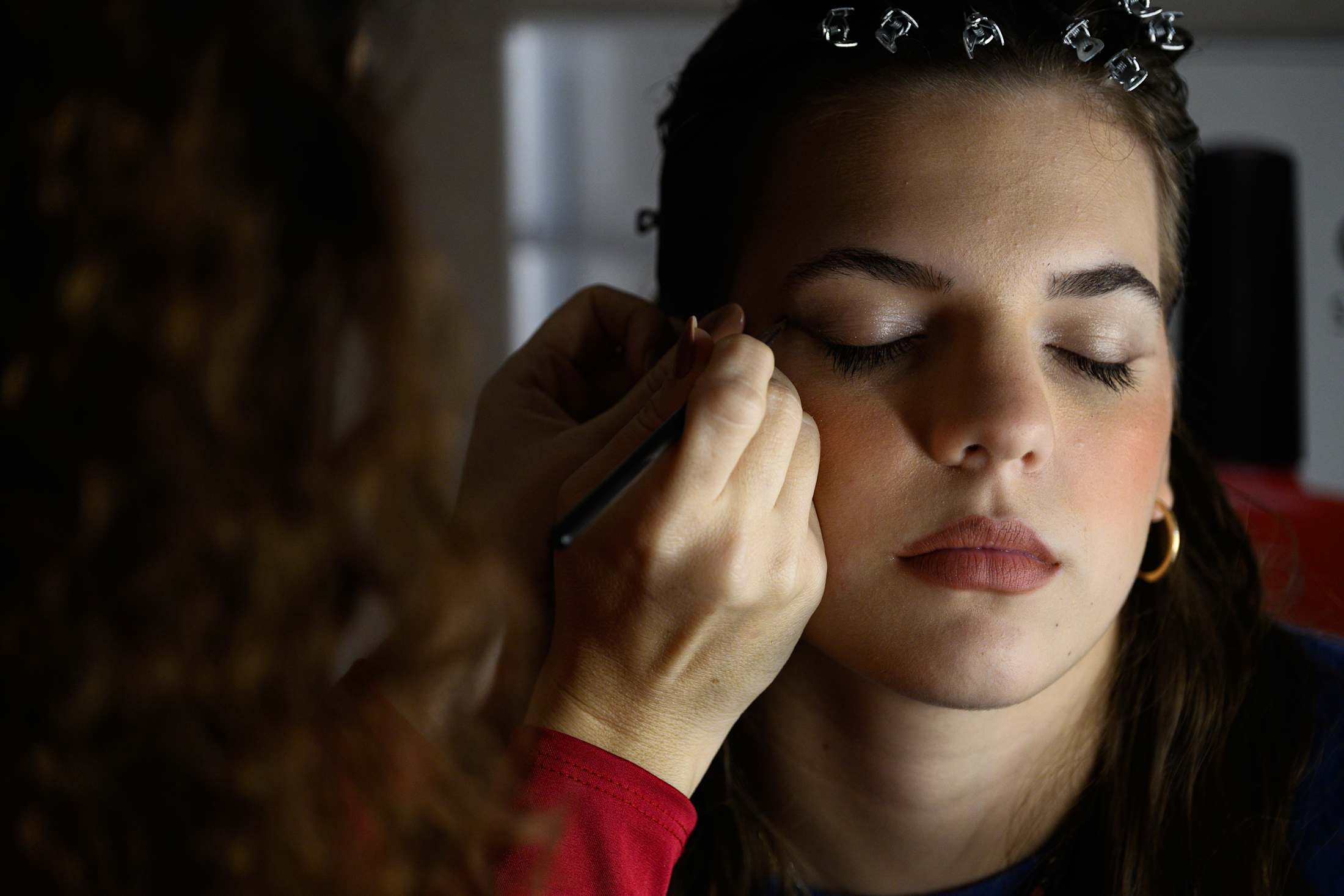 A student has makeup applied during a Sartoria workshop