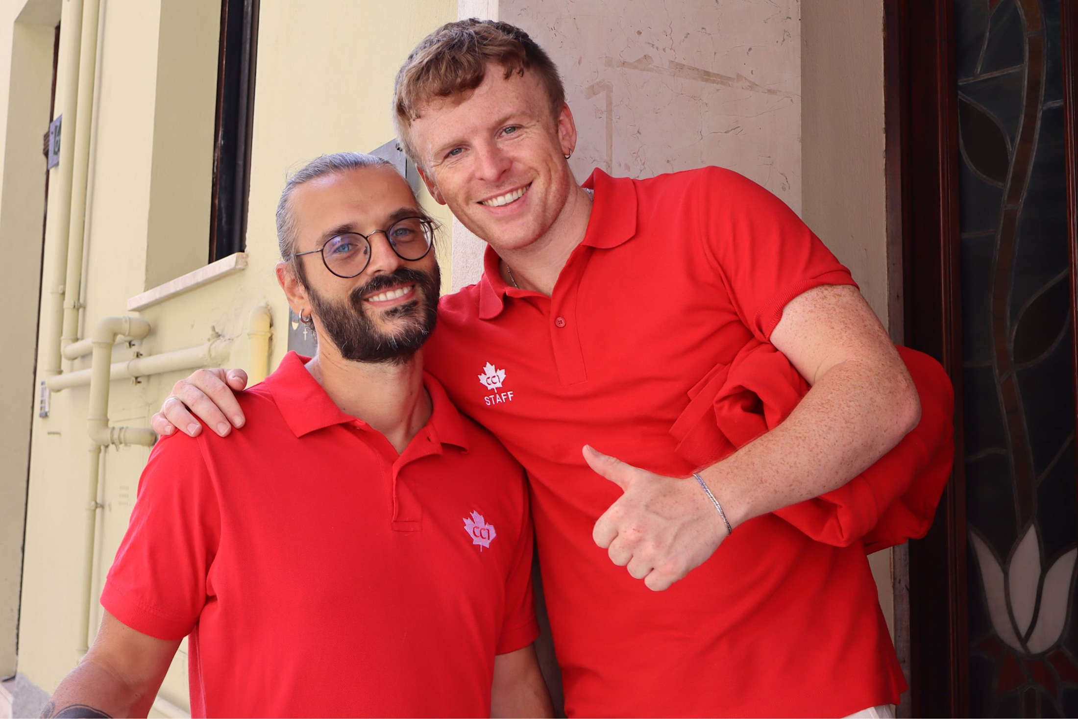 Two CCI staff members at the entrance to a student residence