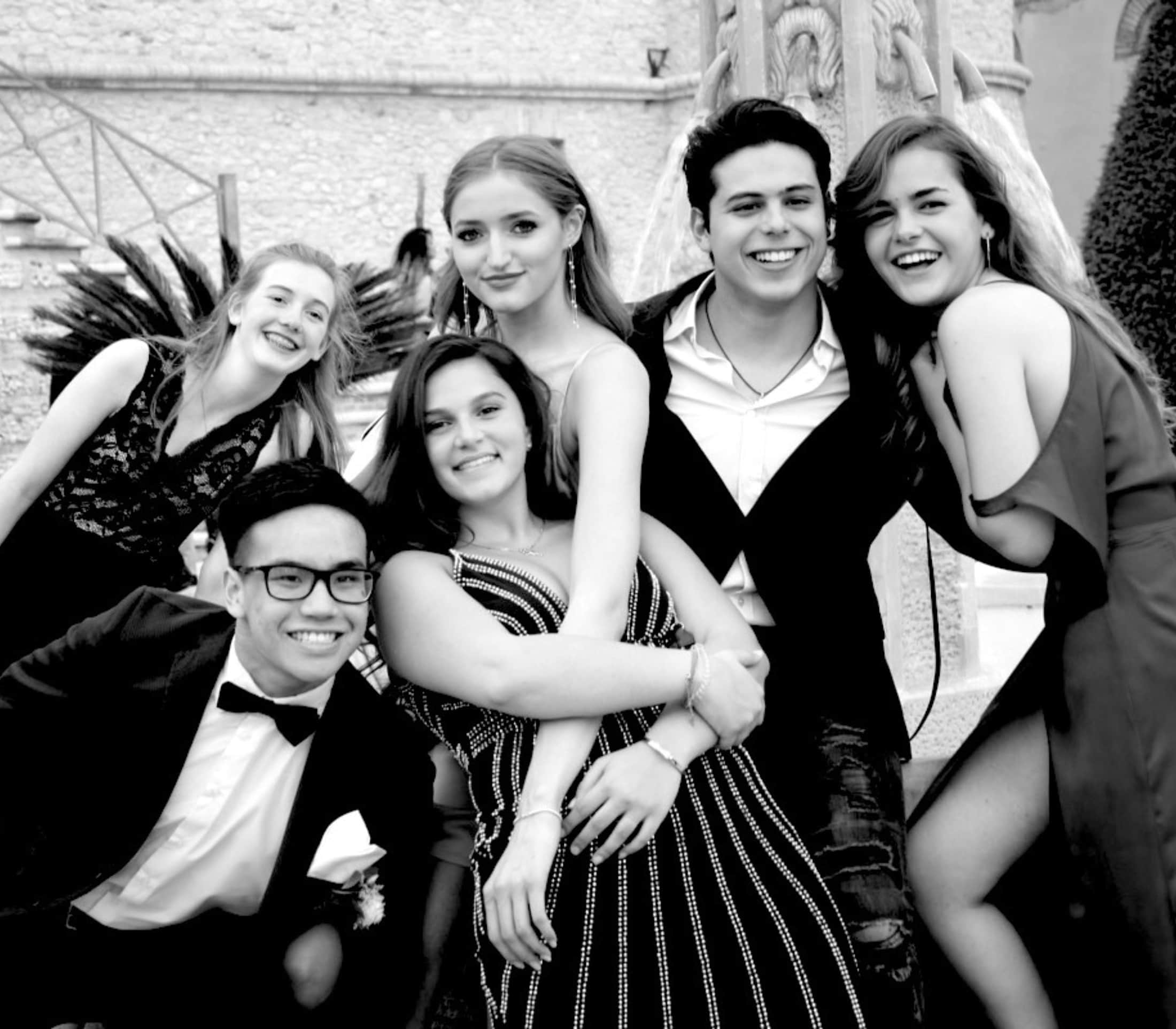 Six members of the CCI community together in formal dress in an alumni photograph