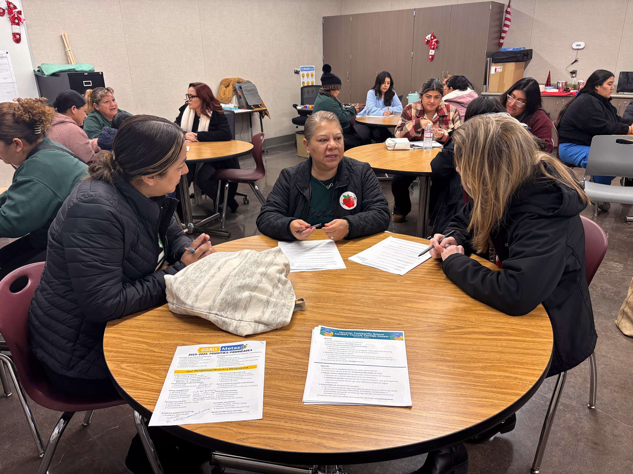 A group of parents gathered at a table for a parent meeting