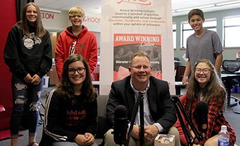 State Superintendent Chris Reykdal with student producers of Enterprise Middle School's "Award Winning Culture" podcast.