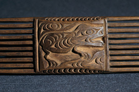 Coast Salish carved comb. On one side a four-legged animal is shown with a clear profile