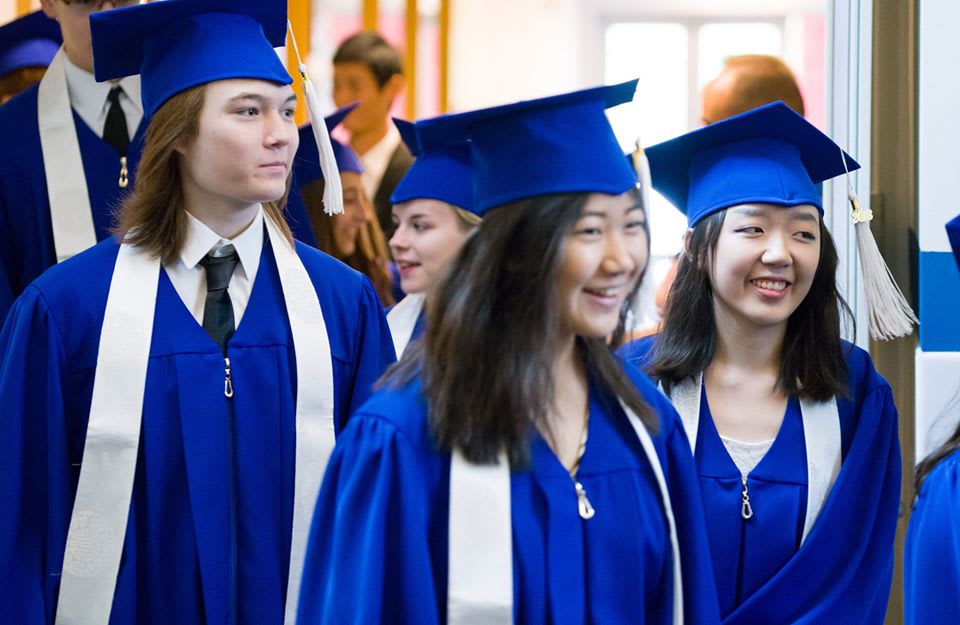 ISB students smiling while heading to graduation