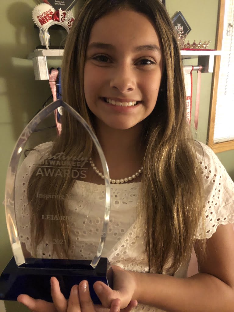 Young Leia Rios receiving Positively Milwaukee Inspiring Youth Award