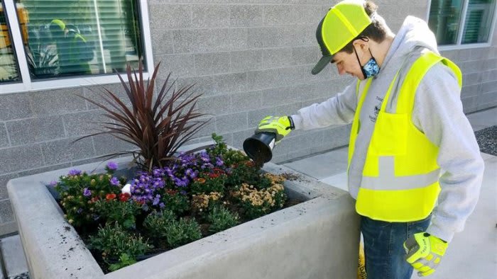 Richland High Senior Brevin Wickham works on a planter as part of his Work-Based Learning experience with RSD grounds staff.
