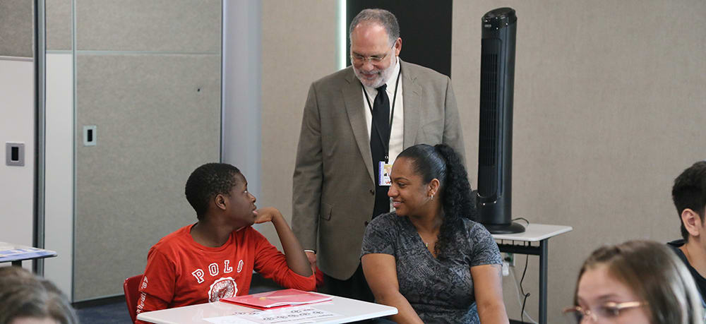 Interim Superintendent Michael Tolley talks with a student