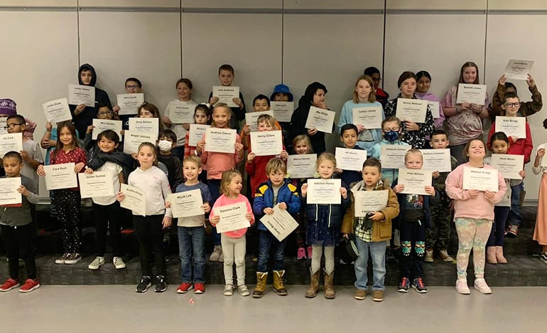 Students at Sacajawea Elementary show off their recognition certificates for showing positive behavior and characteristics.