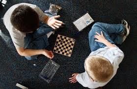 Two students focused on a game of chess