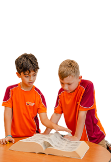 Two boyrs reading a book