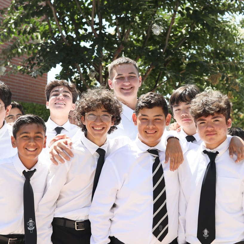 Servite students smiling together on campus