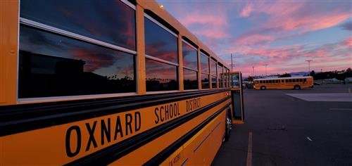 An Oxnard School District school bus at sunset.