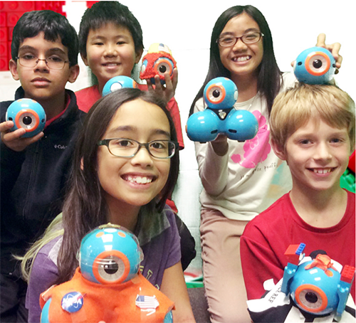 children smiling with robots