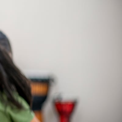 The image shows a close-up view of a person's hair, with a blurred background suggesting an indoor setting.